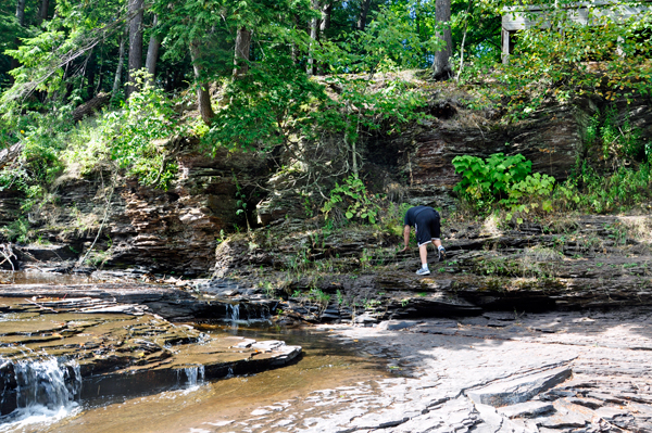 Lee Duquette making his way down the layered edge to the falls